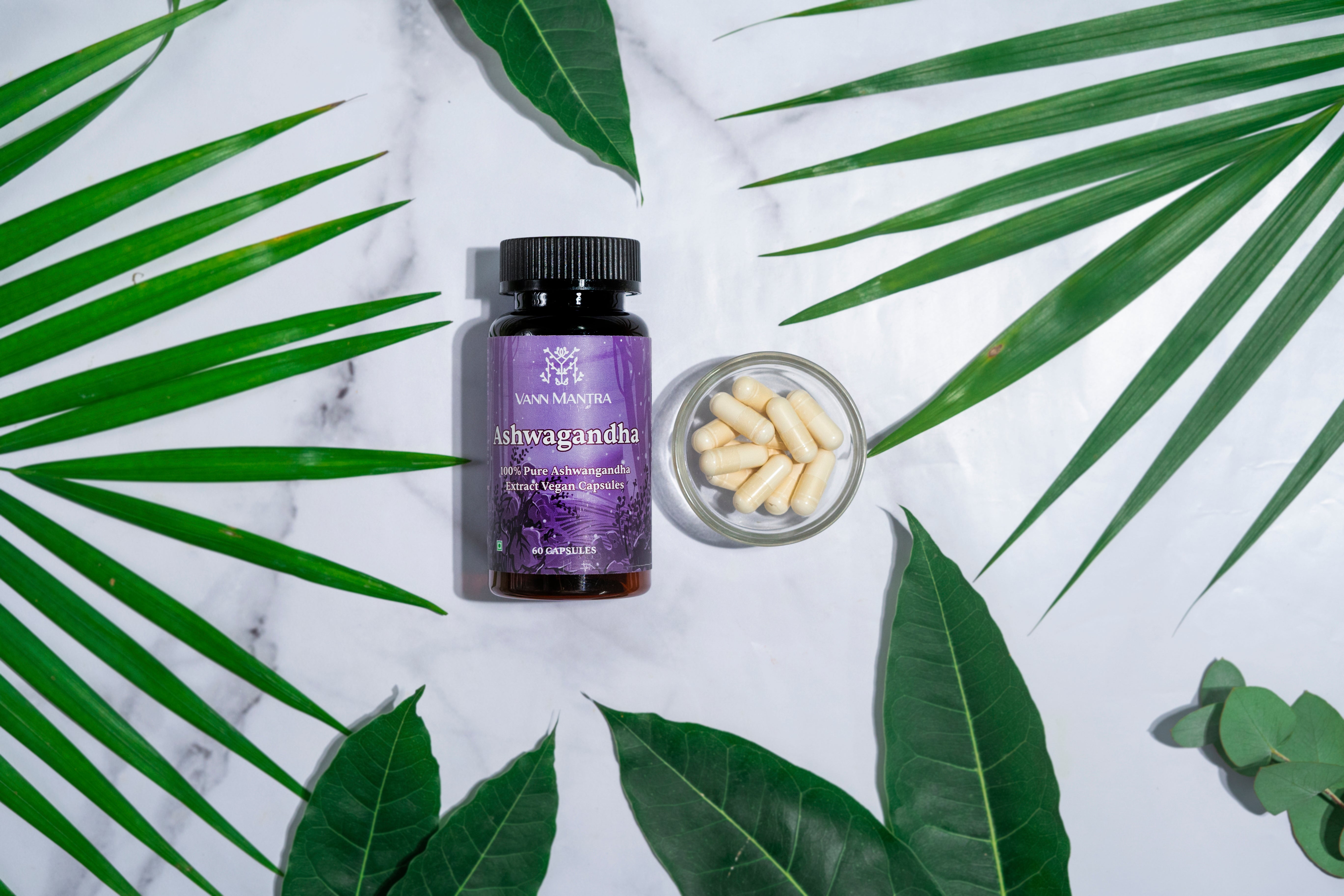 Ashwagandha Capsule on a backdrop with plants.