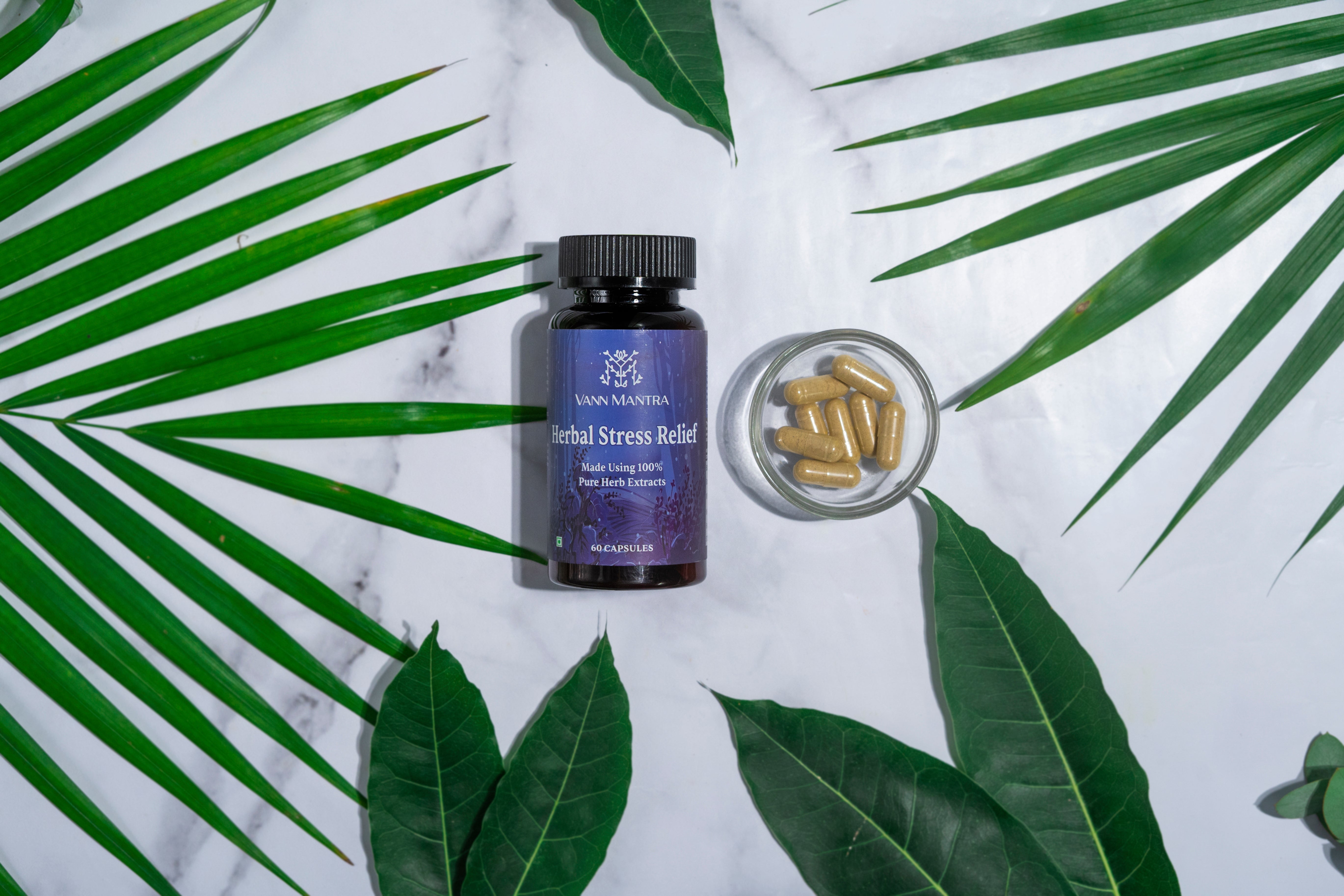 Herbal Stress Relief Capsules  on a backdrop with plants.