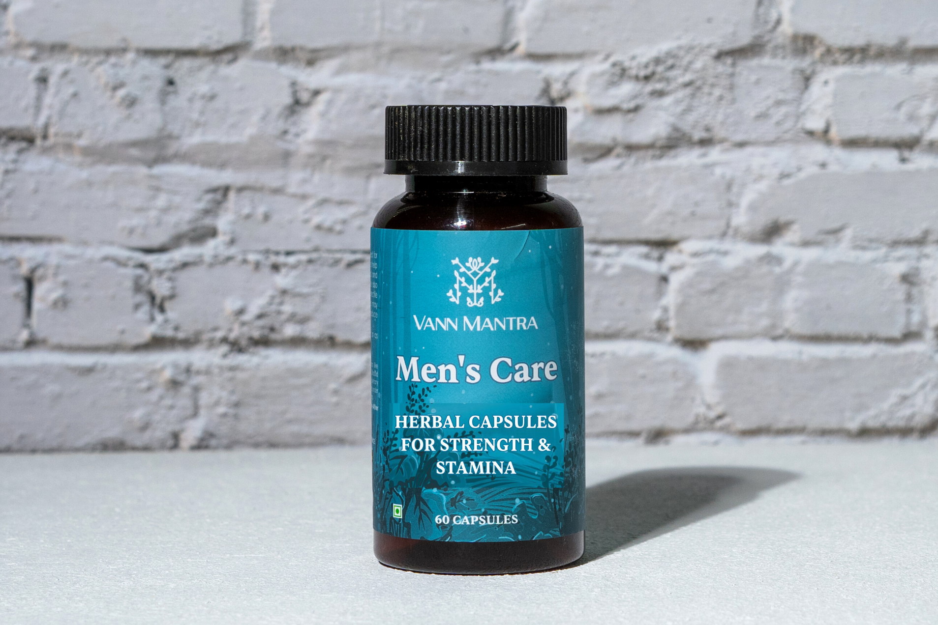 Men's Care Capsules in front of a brick wall 