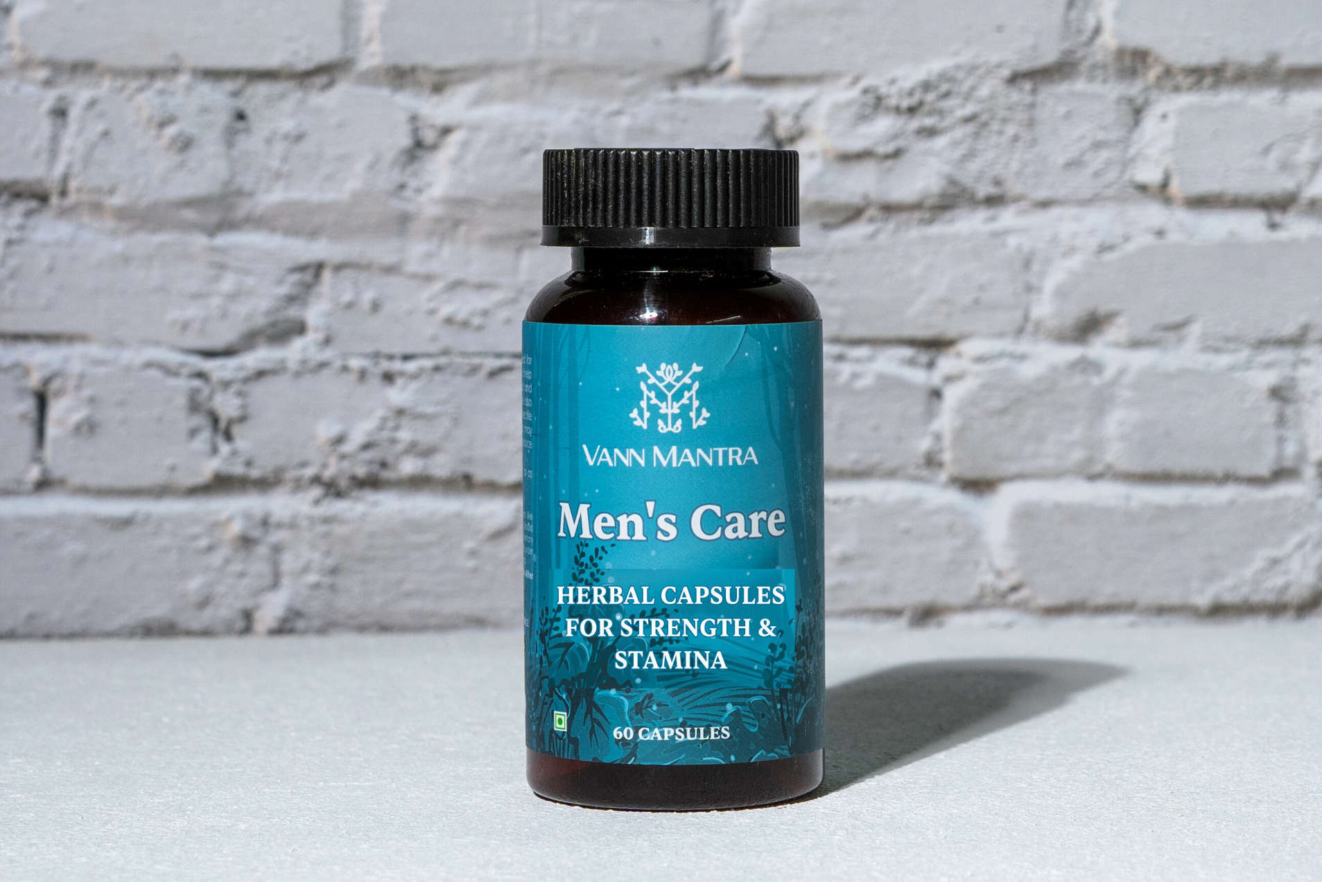 Men's Care Capsules in front of a brick wall