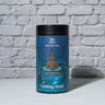 Calming Monk Tea in front of a brick wall 