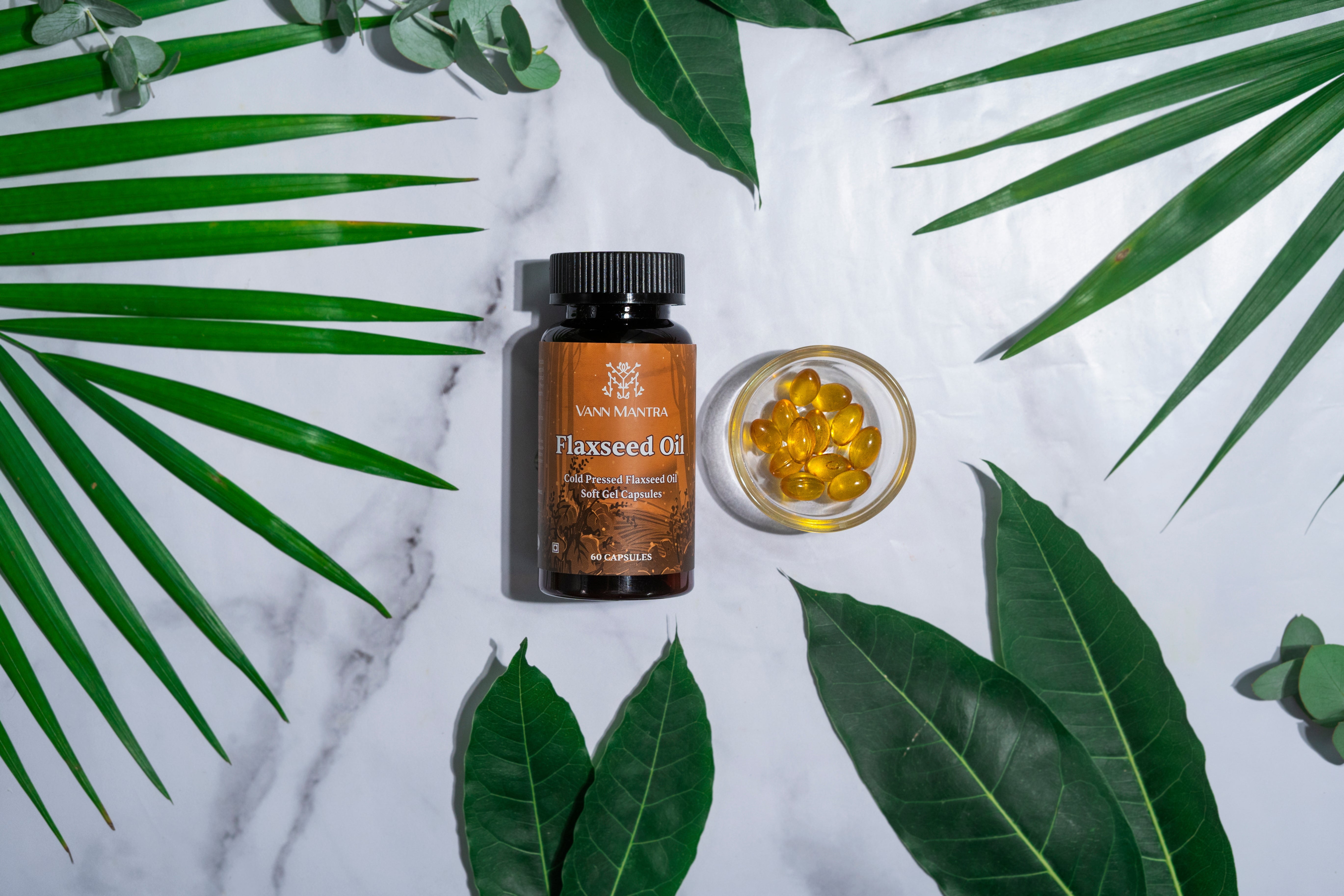 Flaxseed Oil Capsule on a backdrop with plants. 