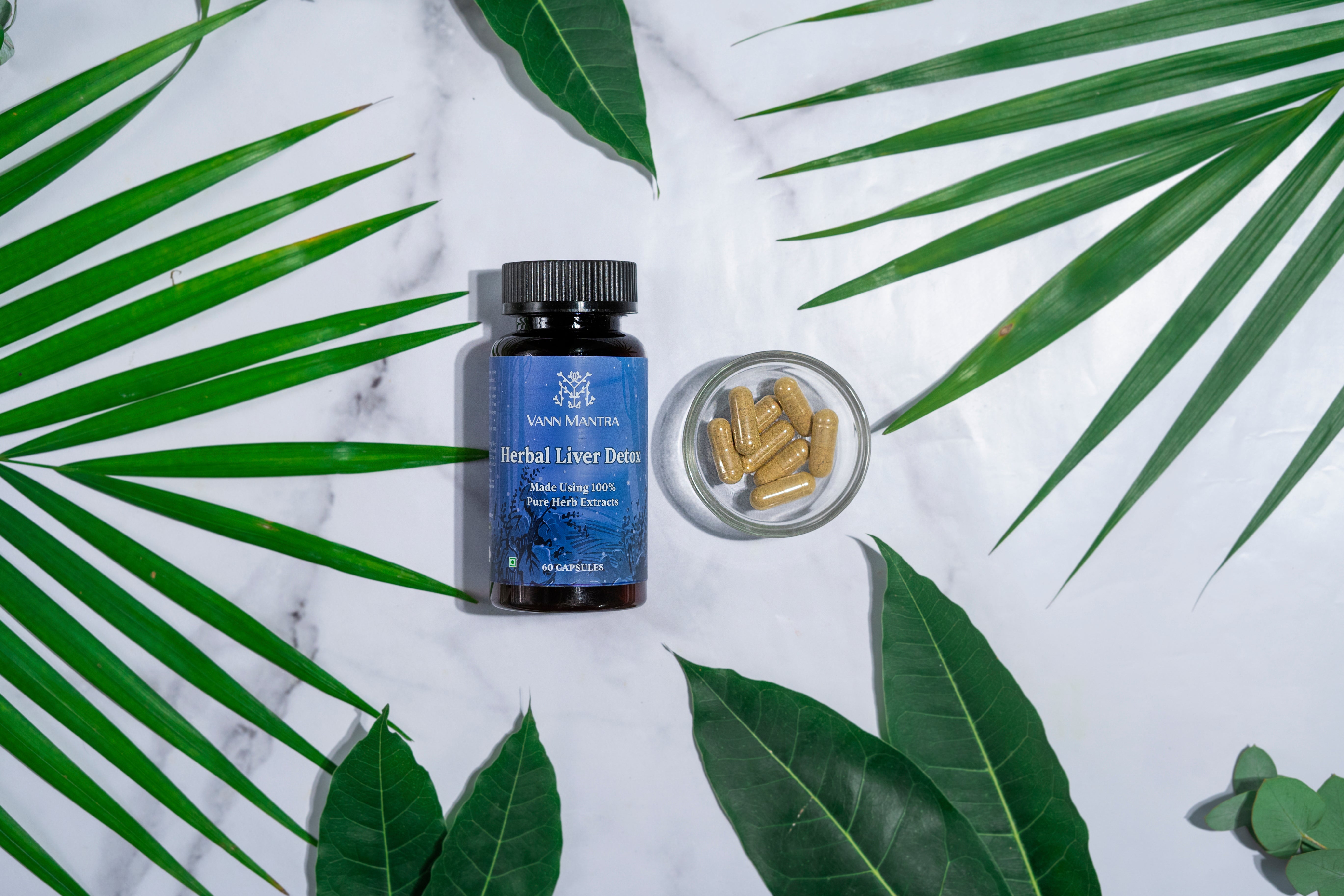 Herbal Liver Detox Capsules on a backdrop with plants. 