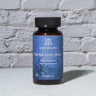 Herbal Liver Detox Capsules in front of a brick wall 