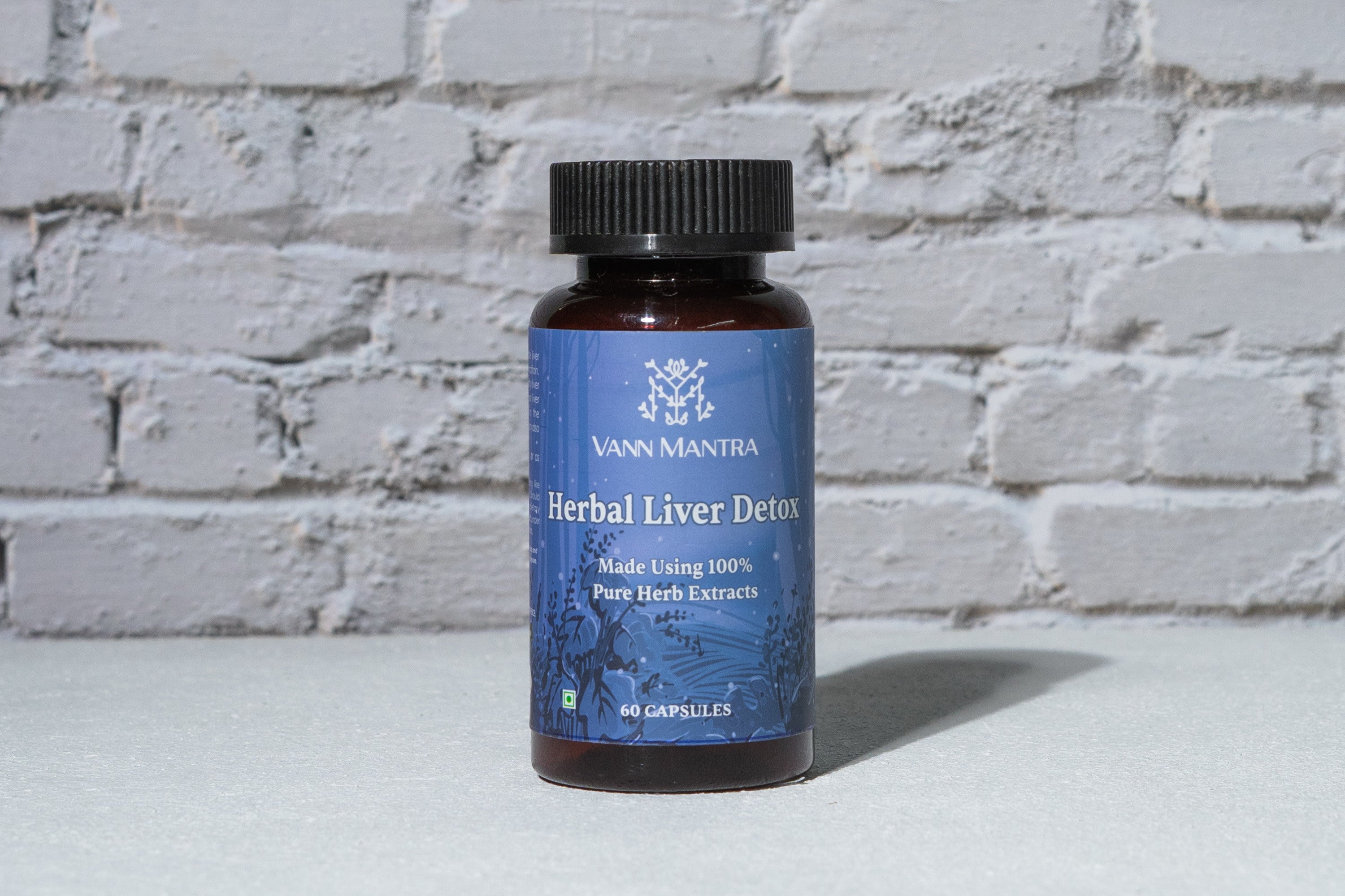 Herbal Liver Detox Capsules in front of a brick wall 