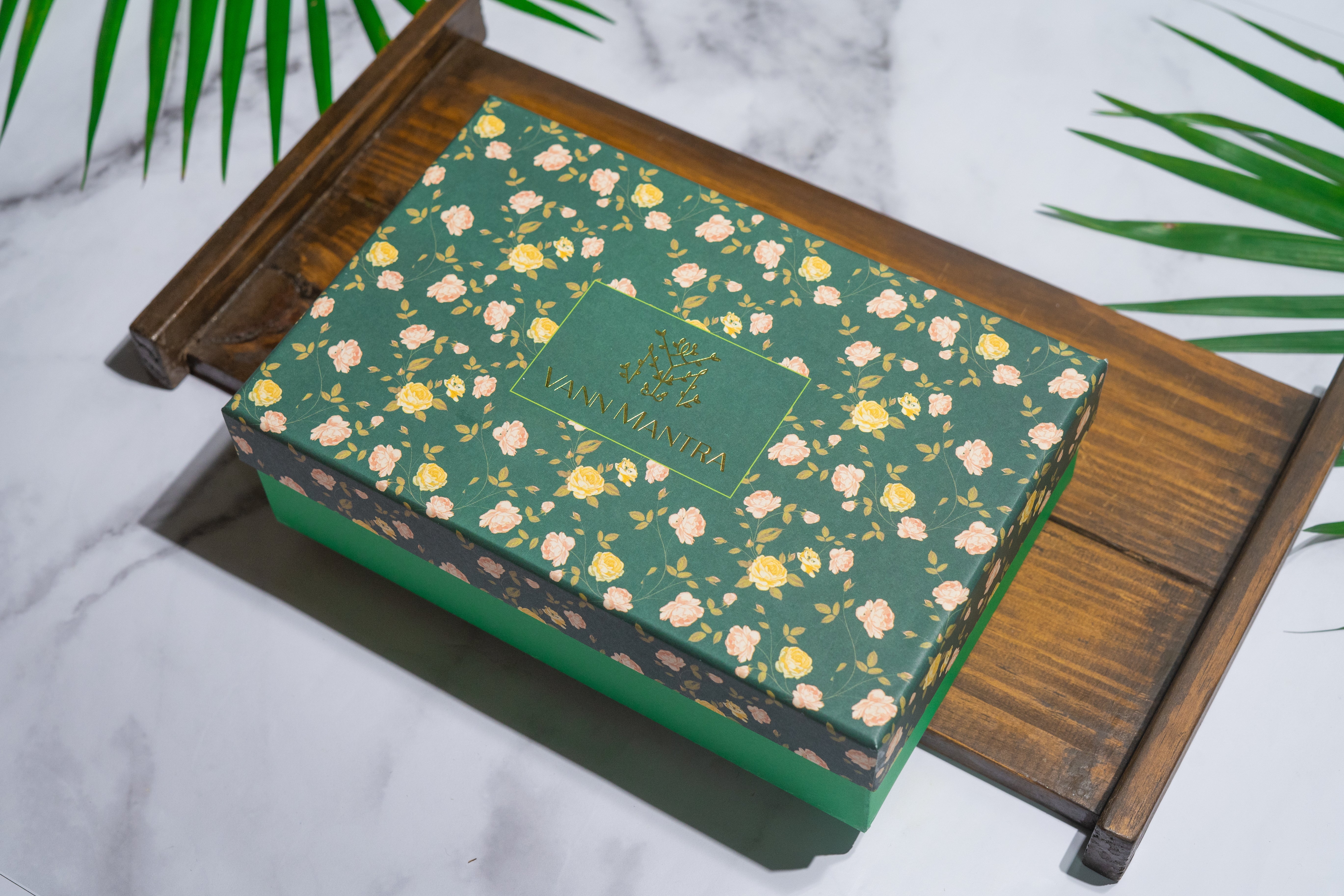 Box Of Serenity (Kashmiri Kahwa, Calming Monk, Lychee Honey) on a wooden tray.