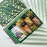 Box Of Grandma's Immunity Secrets ( Kashmiri Kahwa, Flaxseed Oil Capsule, Blackseed Oil Capsule, Turmeric Curcumin Capsule) on a backdrop with plants.