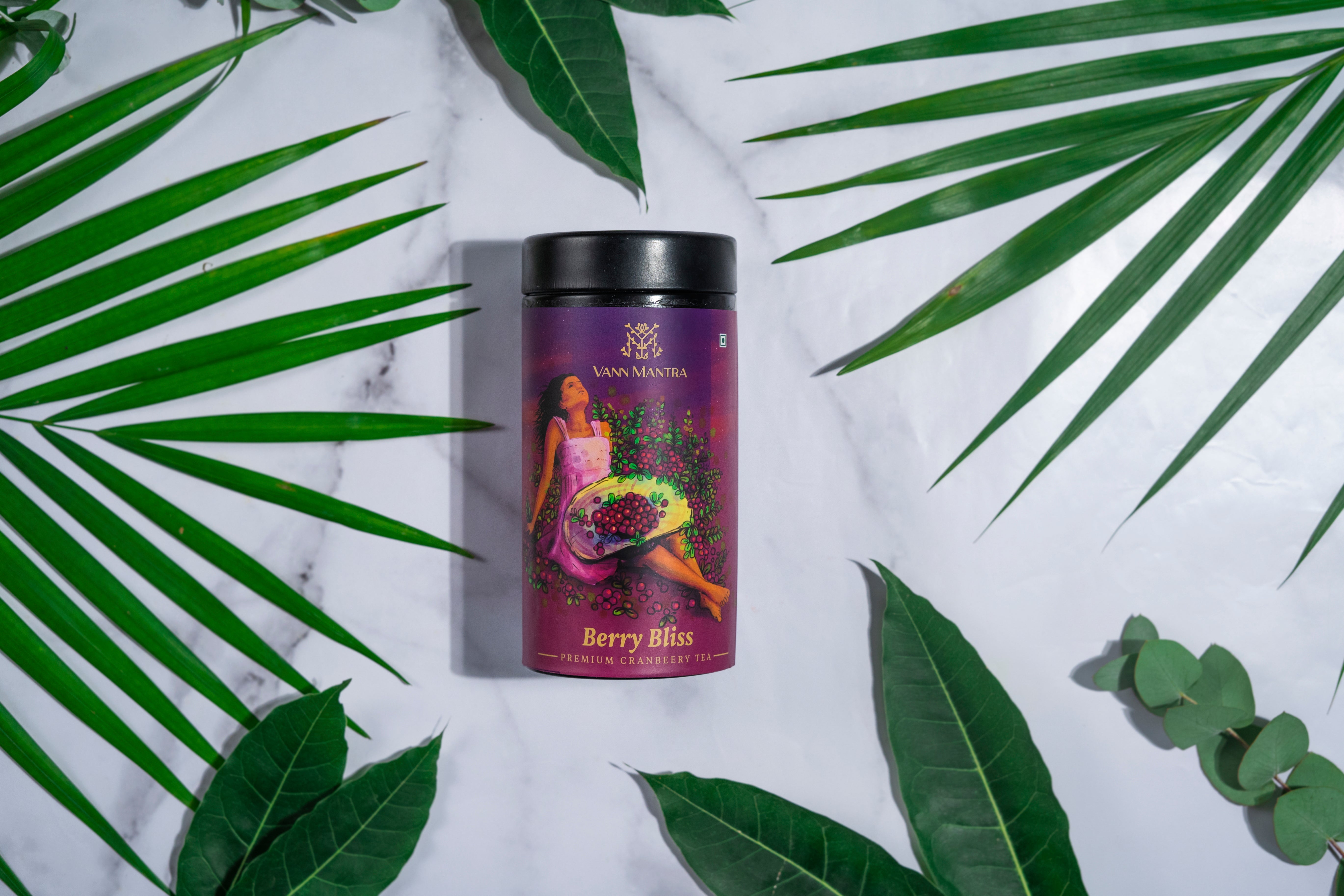 Berry Bliss Cranberry Tea on a backdrop with plants. 